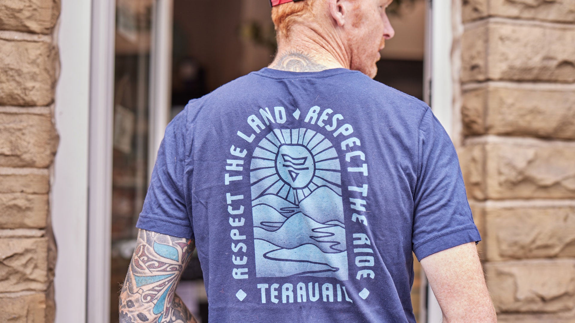 Person wearing Teravail Landmark T-Shirt showing back design with Teravail logo