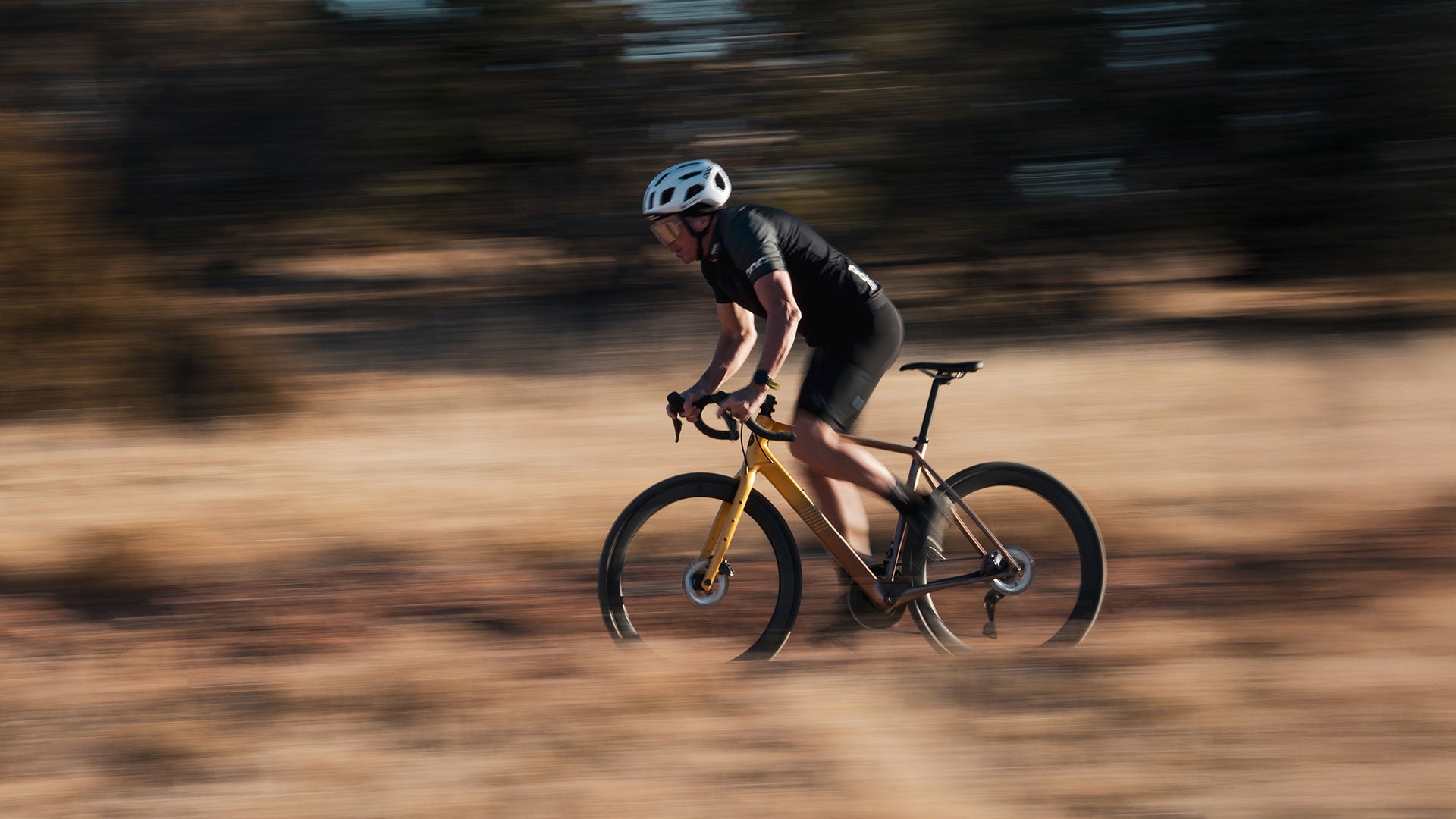 Cyclist out of saddle riding drop bar road bike